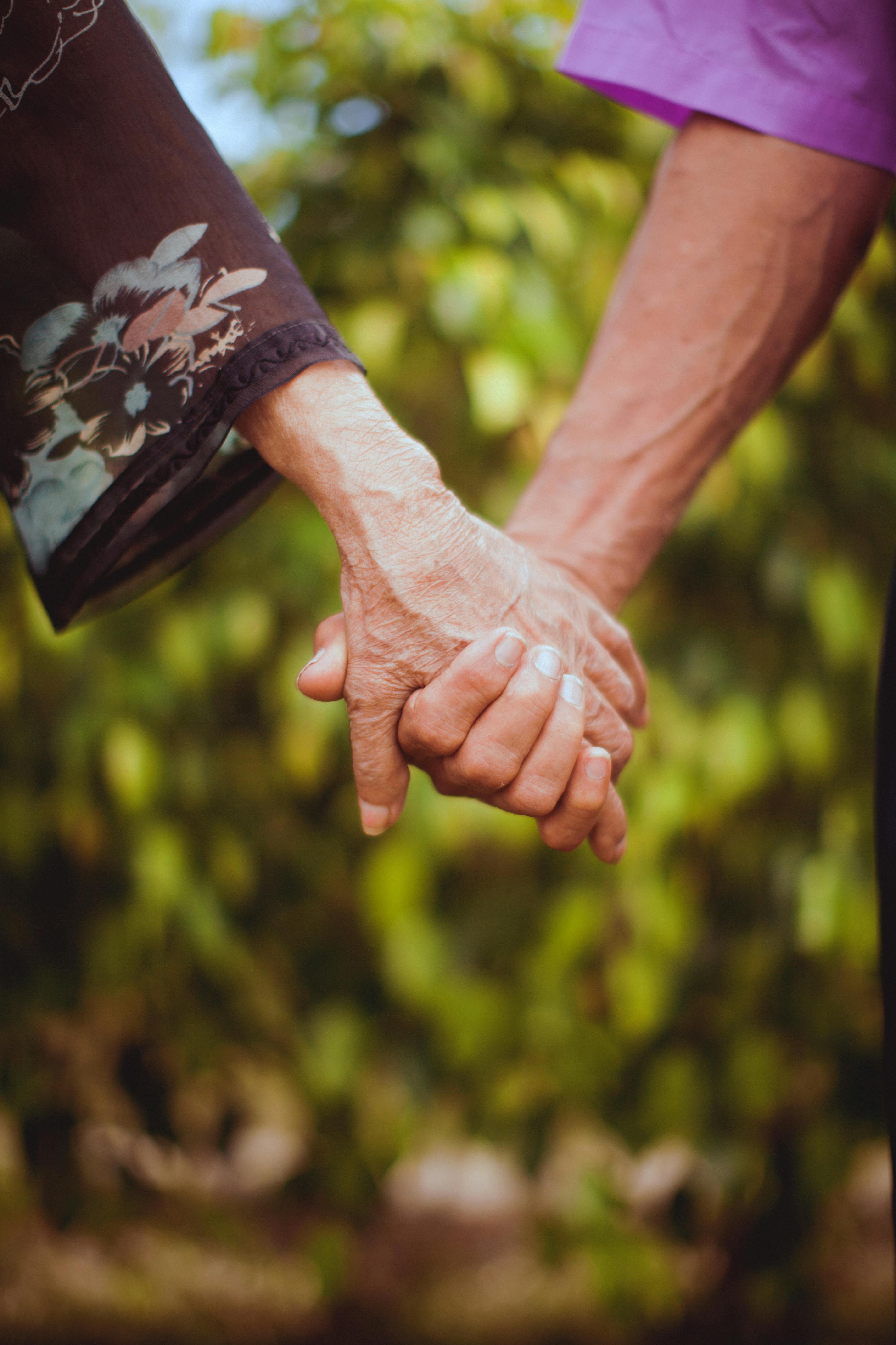 Senior couple holding hands