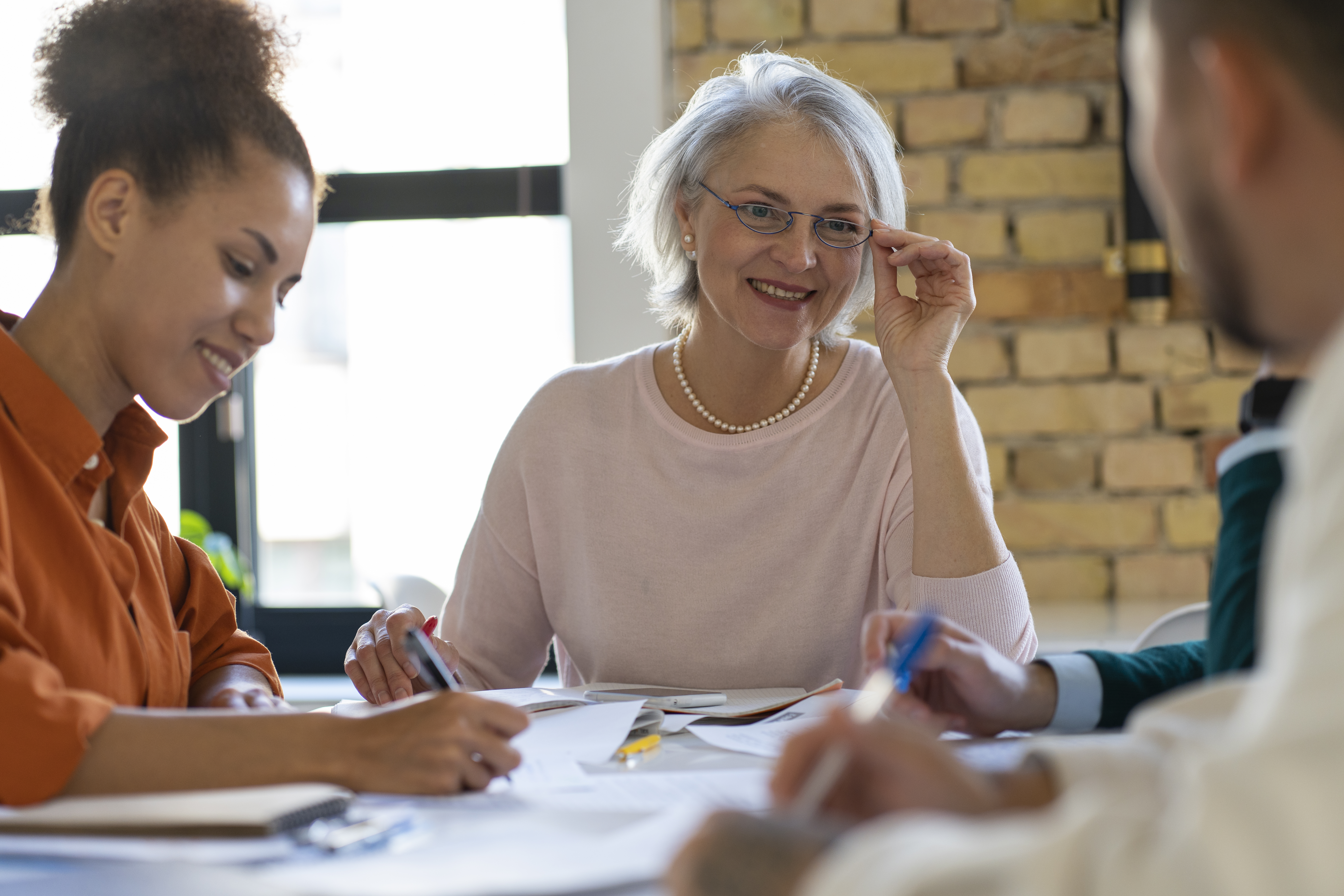 Senior woman smiling during health insurance consultation