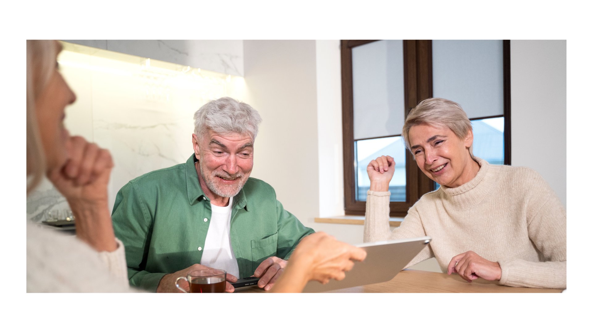Senior couple smiling with health insurance advisor